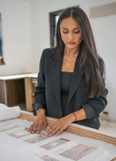 kintoart businesswoman in a tailored suit reviews architectural plans
