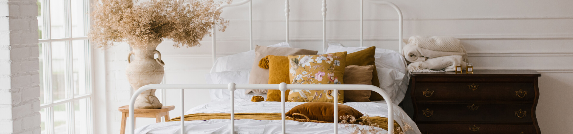 kintoart white bed featuring a combination of yellow and white pillows exuding a fresh and cheerful ambiance